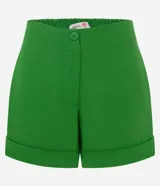 Short color verde esmeralda confeccionado en tejido de lino y viscosa, con cintura elástica, cierre tradicional y bajo plegado.