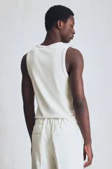 Musculosa blanca de punto acanalado, con cuello redondo y corte ajustado.