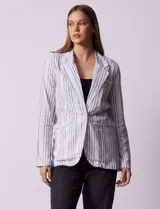 Blazer blanco con rayas verticales negras, cuello con solapa, abertura central con botón y bolsillos delanteros.