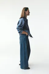 Pantalón de jean azul de corte ancho, tiro alto y efecto lavado.