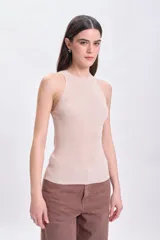 Musculosa beige de punto con brillo sutil.
