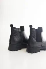 Botas cortas marrones con textura símil cuero de reptil, elástico lateral, cierre lateral con cremallera y suela track.