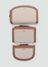Billetera pequeña color beige con efecto rafia y logo en relieve. Tiene cierre de solapa con botón magnético, seis ranuras para tarjetas y cierre de cremallera.