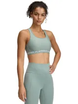 Top deportivo Under Armour color verde agua, con espalda cruzada y logo de la marca en la banda inferior.
