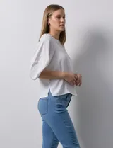Blusa de gasa blanca, marca Sioni. Cuello a la base y escote en V con botones.