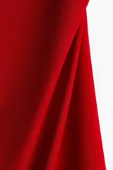 Vestido corto rojo de punto suave con escote cuadrado y breteles spaghetti. Diseño ajustado con frunces laterales y falda con leve vuelo.