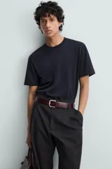 Camiseta blanca de algodón de peso medio, corte recto, cuello redondo y mangas cortas.