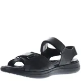 Sandalias negras de mujer, estilo casual, con tiras ajustables mediante velcro en el empeine y tobillo. Presentan una suela gruesa y ergonómica con plantilla contorneada. Se observa un logo grabado en la tira del tobillo.