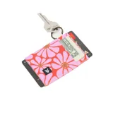 Billetera elástica en colores vibrantes con estampado de flores, cuenta con anillo para llaves.
