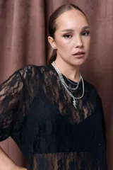Remerón negro de encaje con mangas cortas y cuello redondo.