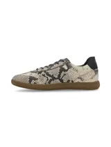 Zapatillas acordonadas doradas de cuero, con suela marrón de goma.