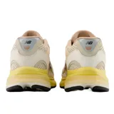 Championes New Balance U2010Sgr, capellada de malla color crema con refuerzos en cuero color beige, entresuela de goma color amarillo y logo "N" en los laterales.