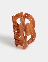 Broche para el pelo color carey con forma de pretzel.