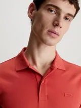 Chomba de piqué de algodón orgánico color ladrillo, corte slim, cuello clásico con dos botones, mangas cortas con puños de punto y logo bordado en el pecho.
