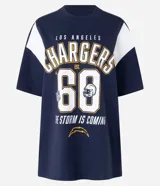 Remera deportiva oversize de algodón, color azul marino con mangas cortas blancas. Estampa frontal con el nombre "Los Angeles Chargers", el número "60" y el logo de la NFL.