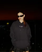 Canguro negro con capucha y bolsillo delantero, con inscripción 'BE TRENDY EST. 2022' en el pecho.