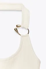 Top negro de tejido rib con escote asimétrico, manga sisa y tirante ancho con detalle de aro metálico dorado.