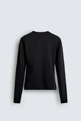Camiseta negra de manga larga, corte slim fit, cuello redondo y efecto lavado.