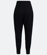 Pantalón zanahoria negro de lino con cintura ancha y pliegues en el bajo.