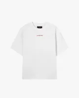 Remera blanca de algodón con corte oversize y estampado grande en la espalda de dos cerezas rojas unidas por el tallo, con el texto "Nude® Project" debajo.