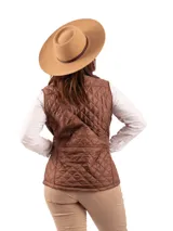 Chaleco verde oliva con diseño capitoneado, cuello alto, cierre frontal con botones a presión, bolsillos laterales con solapa y detalles en cuero marrón.