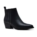 Botas cortas negras de cuero sintético, con elástico lateral, punta fina y taco bajo.