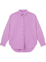 Camisa lila de corte relajado, con cuello clásico, cierre frontal con botones y logo de Calvin Klein Jeans bordado en el pecho.