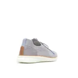 Zapatillas deportivas de punto color beige, con cordones y suela blanca.