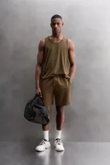 Bermudas jogger negras confeccionadas en tejido de algodón con interior de rizo. Cintura elástica ajustable con cordón y bolsillos laterales en la cadera.