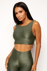 Top deportivo color ladrillo, de poliamida con acabado brillante y textura acanalada, con cuello redondo y espalda escotada.