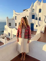 Chaqueta corta color borgoña con bordados florales en tonos azul, rosa y verde.