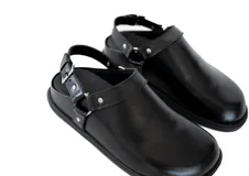 Zueco negro de cuero con diseño slingback y detalle de hebilla metálica.