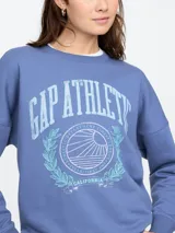 Buzo deportivo azul con cuello redondo, puños y ruedo acanalados. Estampado frontal con el logo de Gap Athletic en color celeste.