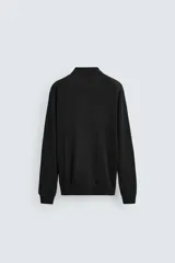 Polo de manga larga color negro, tejido en hilatura con mezcla de algodón y seda, de corte regular fit, con cuello solapa y cierre frontal de botonadura.