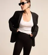Pantalón legging negro de punto roma con cintura elástica y pies.