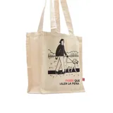 Bolso tipo tote de lona color crudo con asas de algodón. Estampado con dibujo de una persona paseando un perro y la frase "Pasos que valen la pena".