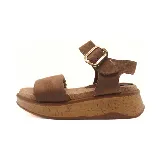Sandalias marrones con plataforma de corcho, tira ancha sobre el empeine y pulsera al tobillo con hebilla dorada.