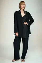Blazer negro de manga larga con cuello solapa y cierre frontal de un solo botón. Presenta bolsillos delanteros con solapas.