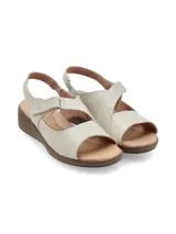 Sandalias de cuero color crema, con plataforma marrón y ajuste de velcro.