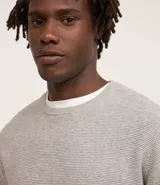 Suéter masculino de manga larga y cuello redondo, color negro, con textura maquinetada y textura dobby.