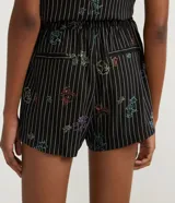 Short negro con rayas verticales blancas y estampado de Tom y Jerry en colores.