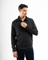 Buzo de punto negro con medio cierre, cuello alto y mangas largas.