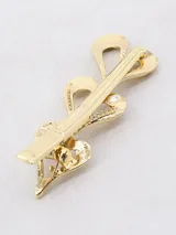Broche dorado para el pelo con tres corazones calados.