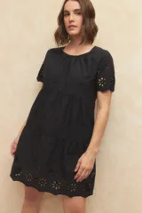 Vestido corto blanco con bordado calado y corte evasé.