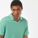 Remera verde de punto de piqué con cuello en V y mangas cortas.