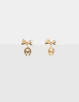Aros colgantes dorados con cabezal de moño y dije de herradura con corazón.