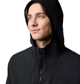 Cortaviento negro con capucha ajustable, cierre frontal con cremallera, bolsillos laterales con cremallera y puños elásticos. Cuenta con tecnología Omni-Shield™ que repele la lluvia y las manchas. Logo de Columbia estampado en el pecho.