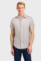 Camisa de manga corta con patrón de rayas en tonos beige y taupe, diseño ligero y moderno.