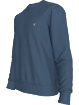 Buzo azul de felpa de algodón y poliéster, de la colección Calvin Klein Jeans. Tiene cuello redondo, manga larga, puños y dobladillo de punto canalé, ajuste regular e insignia con logo de Calvin Klein bordado en el pecho.