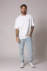 Remera blanca de algodón con cuello redondo y manga corta. Estampado pequeño en el frente.